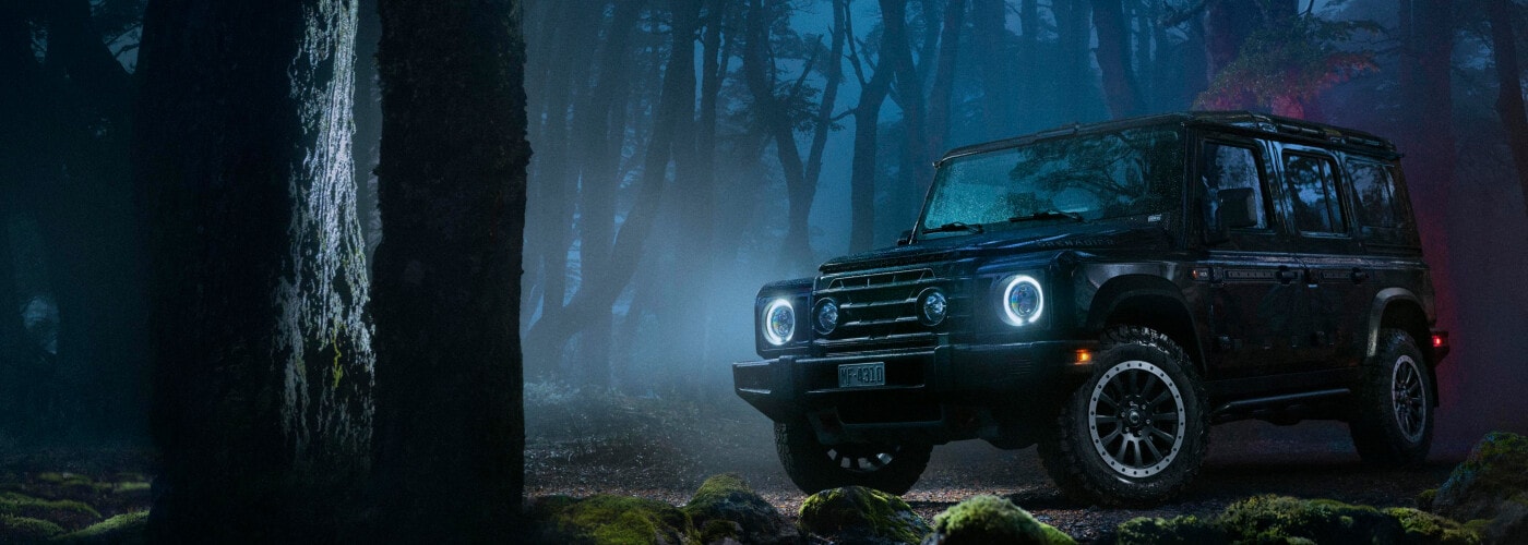 2024 INEOS Grenadier parked in a forest at night