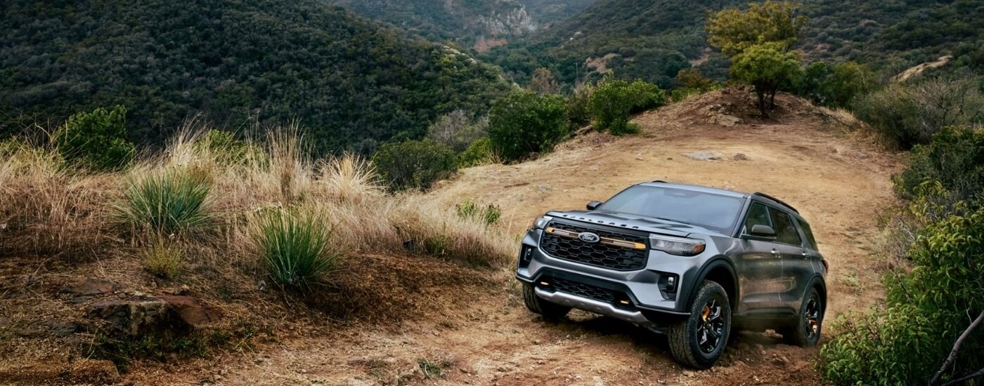 Silver 2026 Ford Explorer Tremor driving up a hill