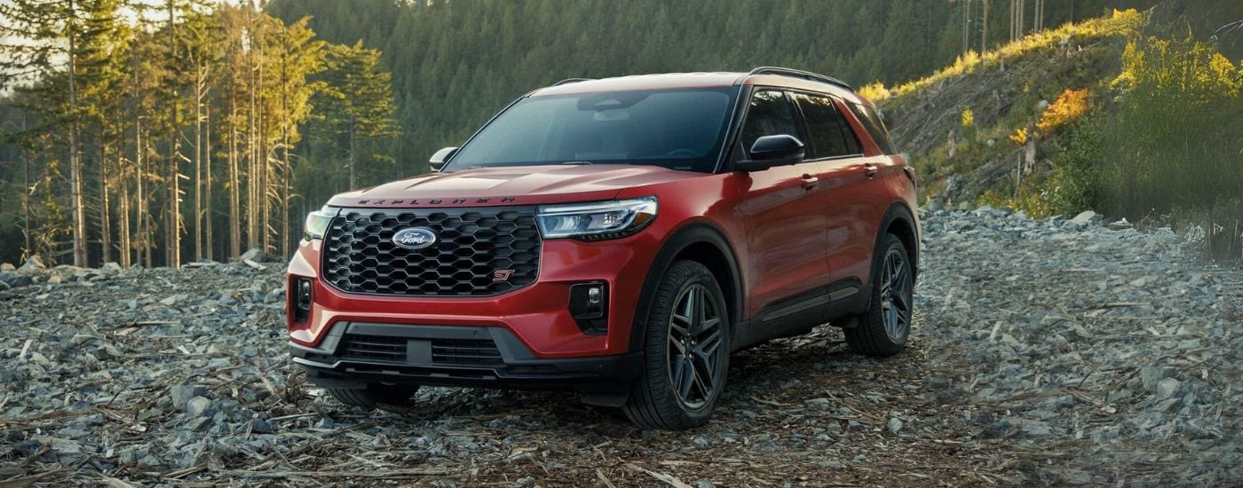 Red 2025 Ford Explorer parked off-road on a rocky trail