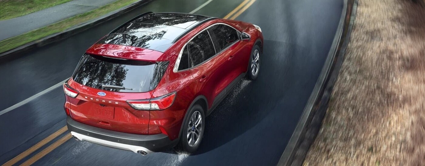A red 2022 Ford Escape for sale is shown driving on wet pavement.