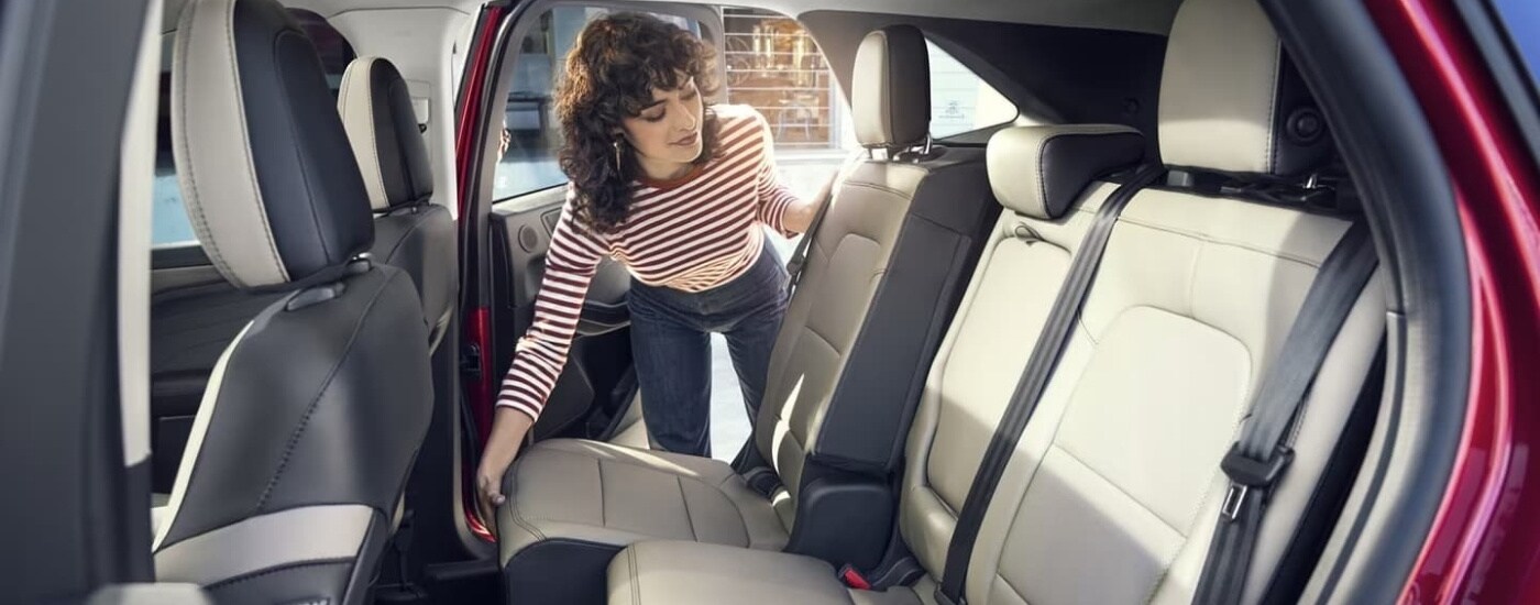 A person is shown adjusting a rear seat in a 2022 Ford Escape.
