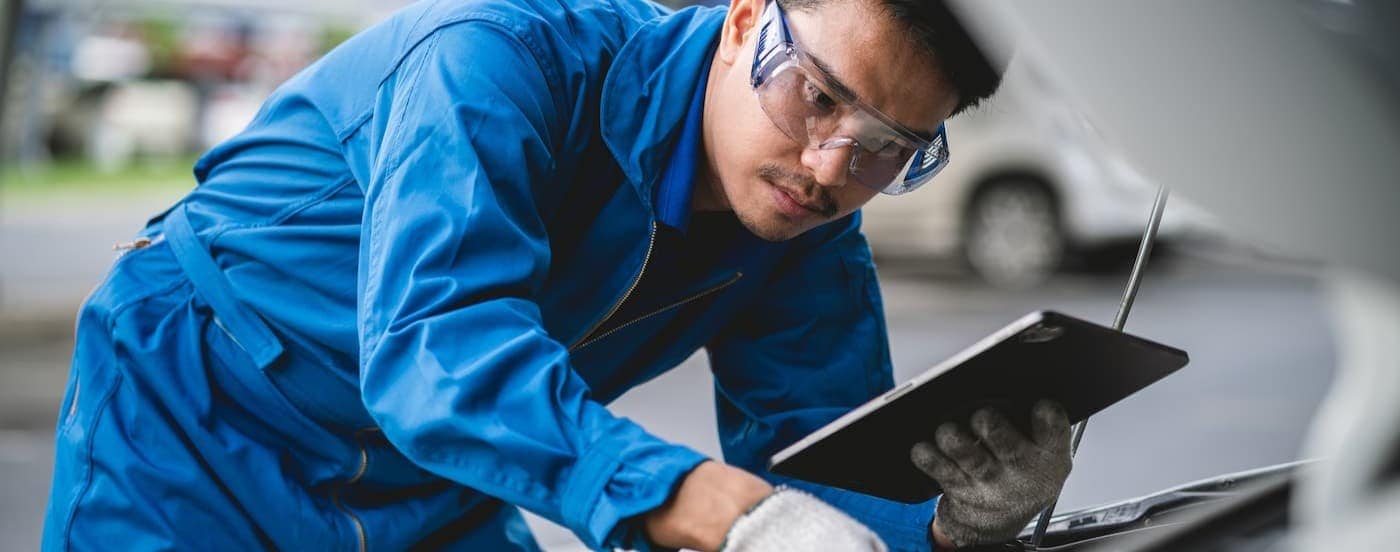 A technician inspecting a vehicle.