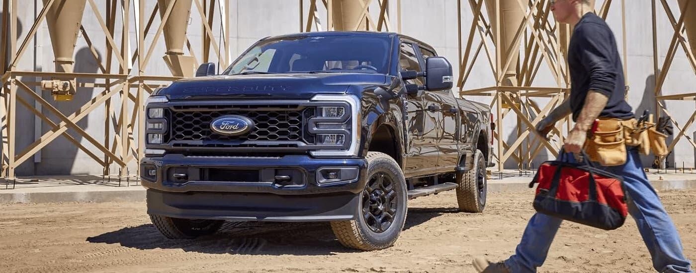 Black 2025 Ford F-250 Super Duty parked at a construction site.