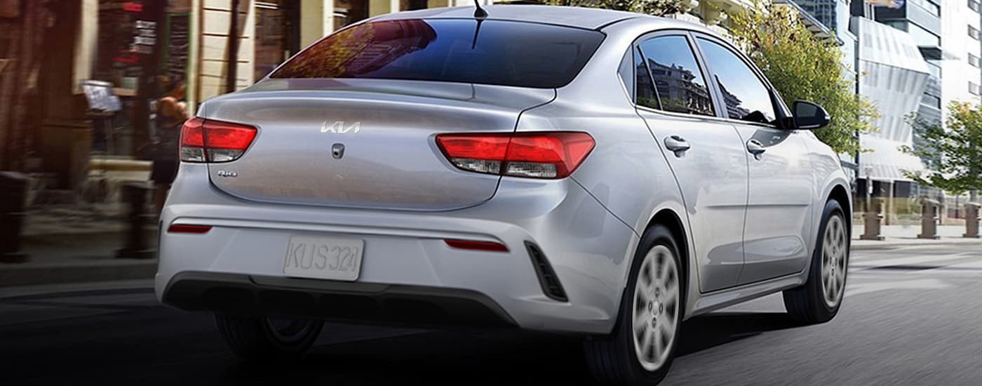 Grey 2023 Kia Rio driving on a city street