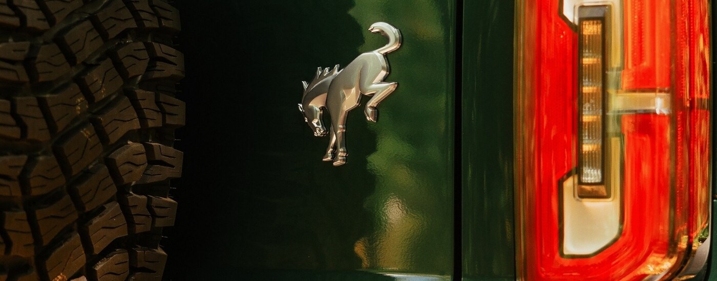 Close-up of the Bronco badge on the back of a green 2025 Ford Bronco for sale near Toledo.
