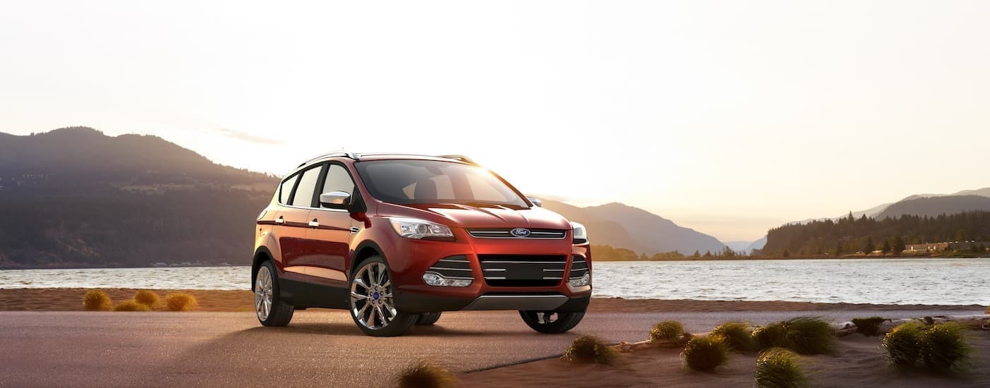 A red 2016 Ford Escape parked near a lake.