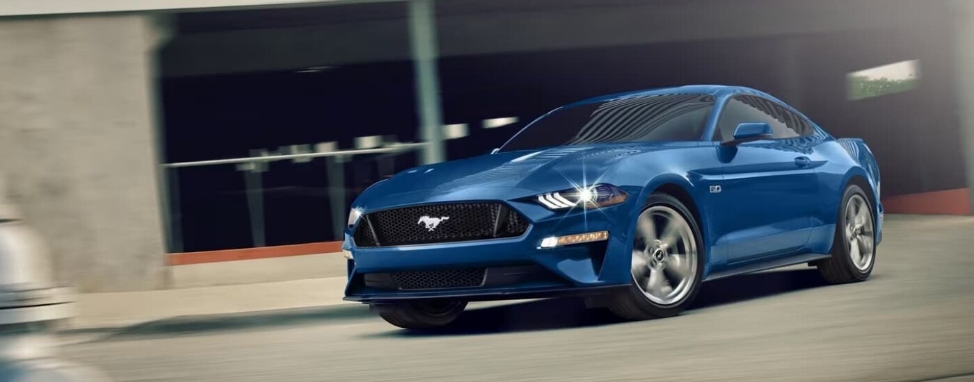 A blue 2023 Ford Mustang GT is shown driving to a Ford dealer near Bucyrus.