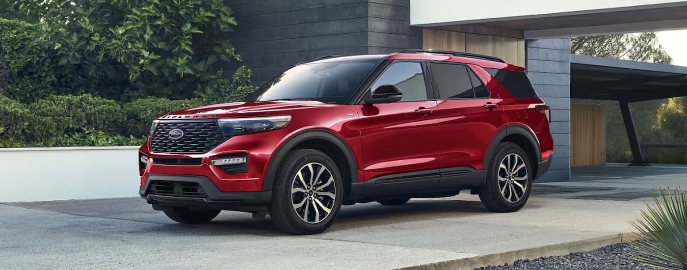 A red 2024 Ford Explorer is shown parked on a driveway.