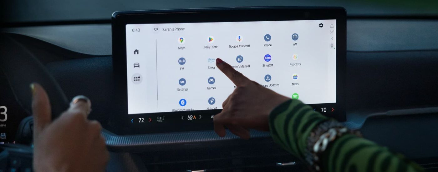Person using the infotainment screen in a 2025 Ford Explorer for sale near Defiance