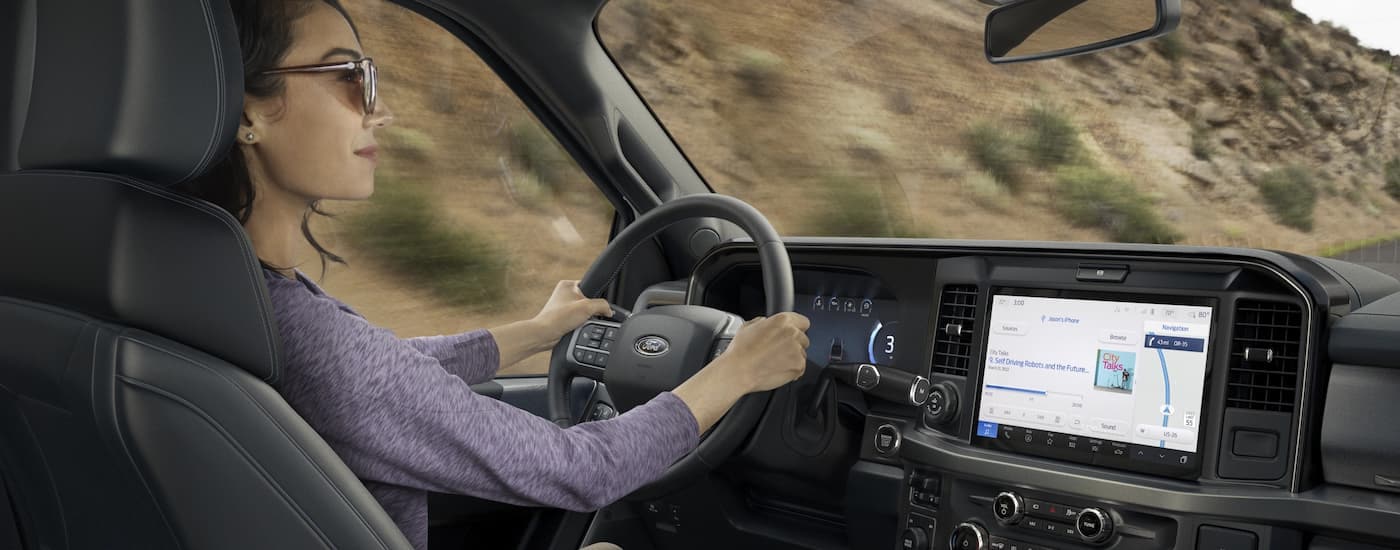 Woman driving in a 2025 Ford F-250 Super Duty for sale near Upper Sandusky.