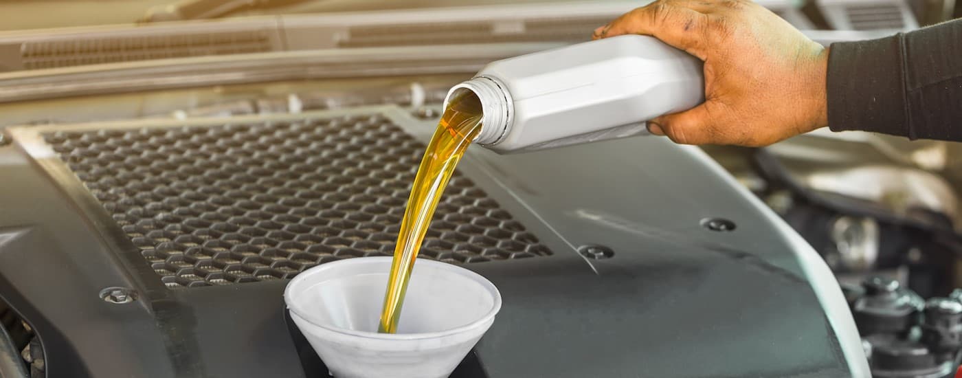 Oil being poured into a funnel.