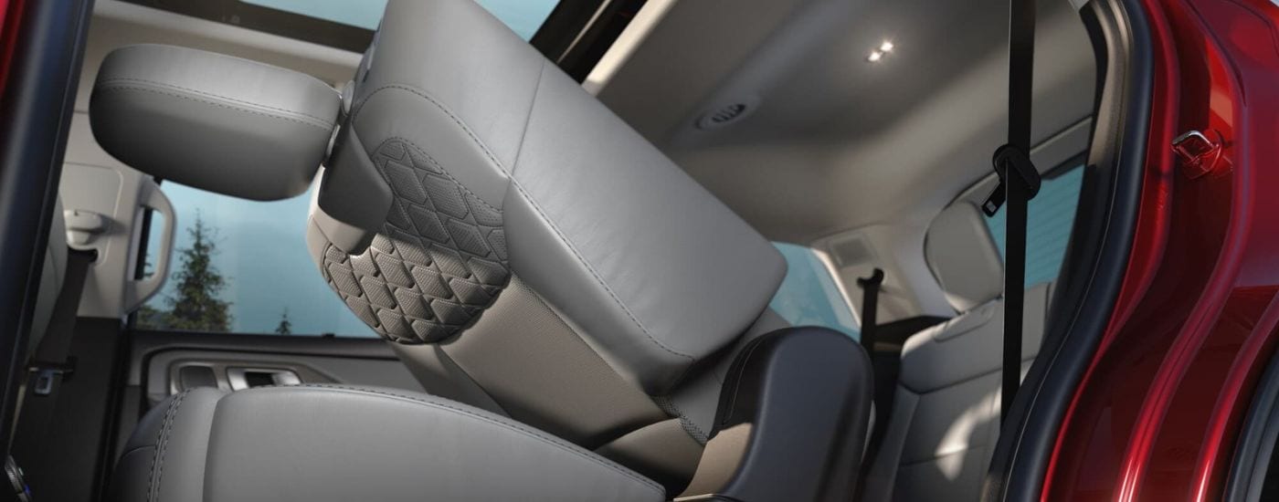 A folded grey seat in the back of a red 2025 Ford Explorer for sale near Bowling Green