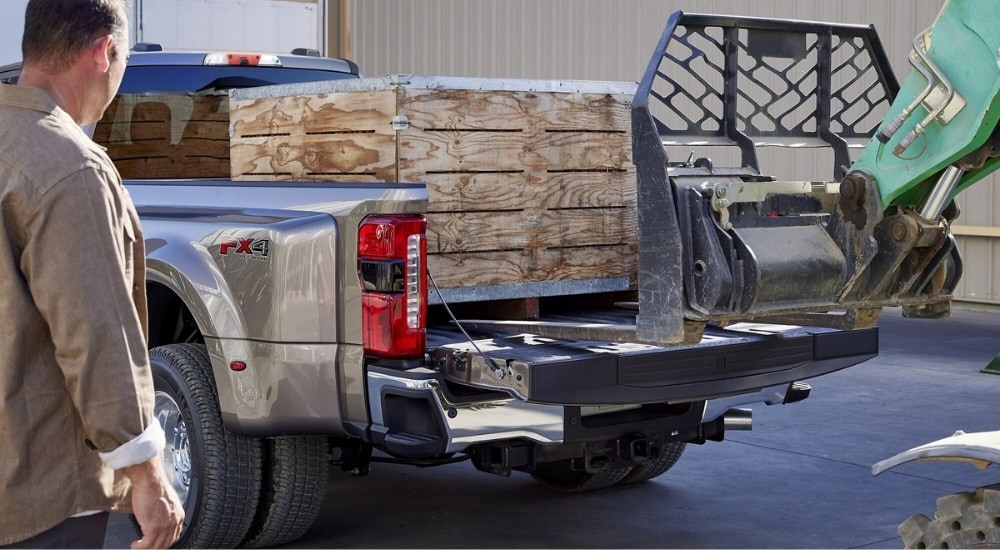 A create is shown being loaded into a 2025 Ford F-350 SUper Duty for sale.