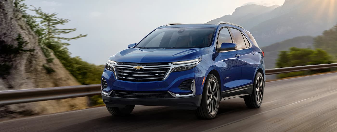 Blue 2023 Chevy Equinox driving on a winding road