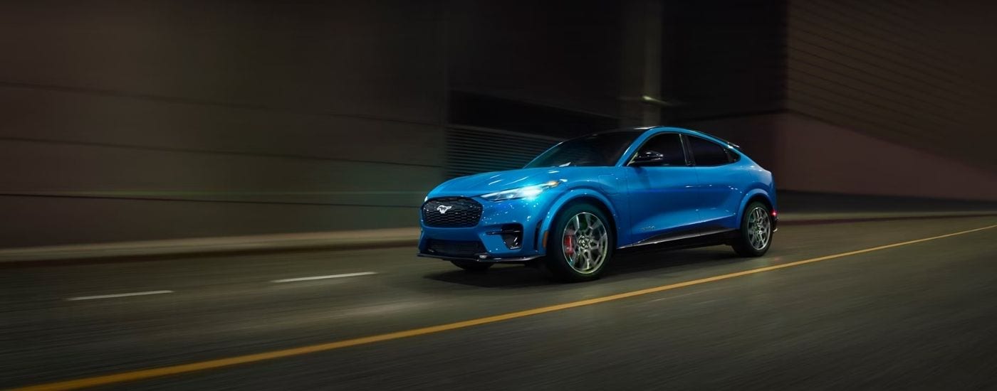 Blue 2026 Ford Mustang Mach-E driving through a tunnel