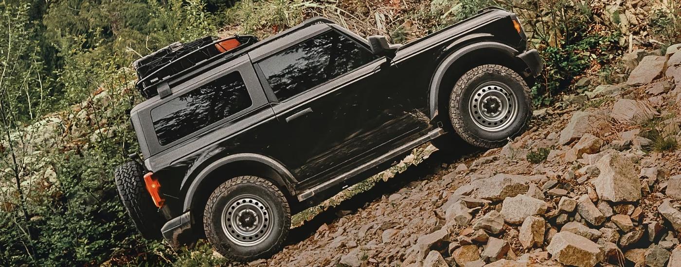 Black 2025 Ford Bronco driving up a steep incline