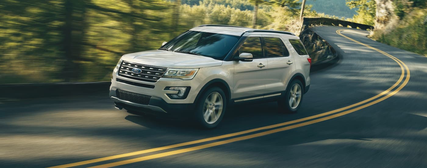 White 2017 Ford Explorer driving down a winding road
