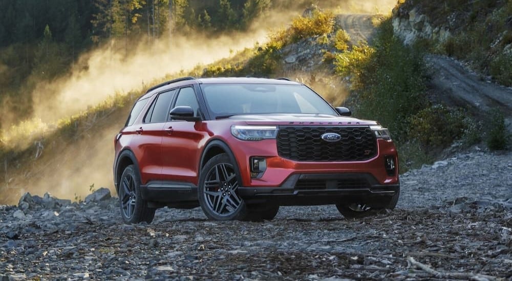 A red 2025 Ford Explorer parked off-road.
