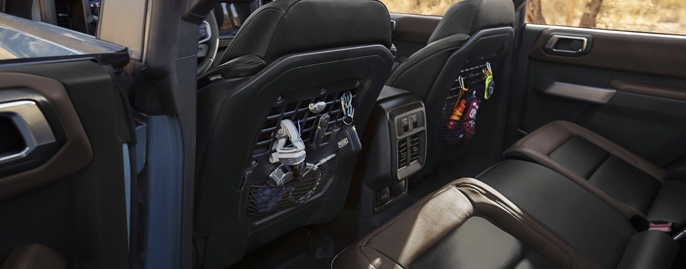 Black molle storage panels are shown on the seats in a 2025 Ford Bronco.
