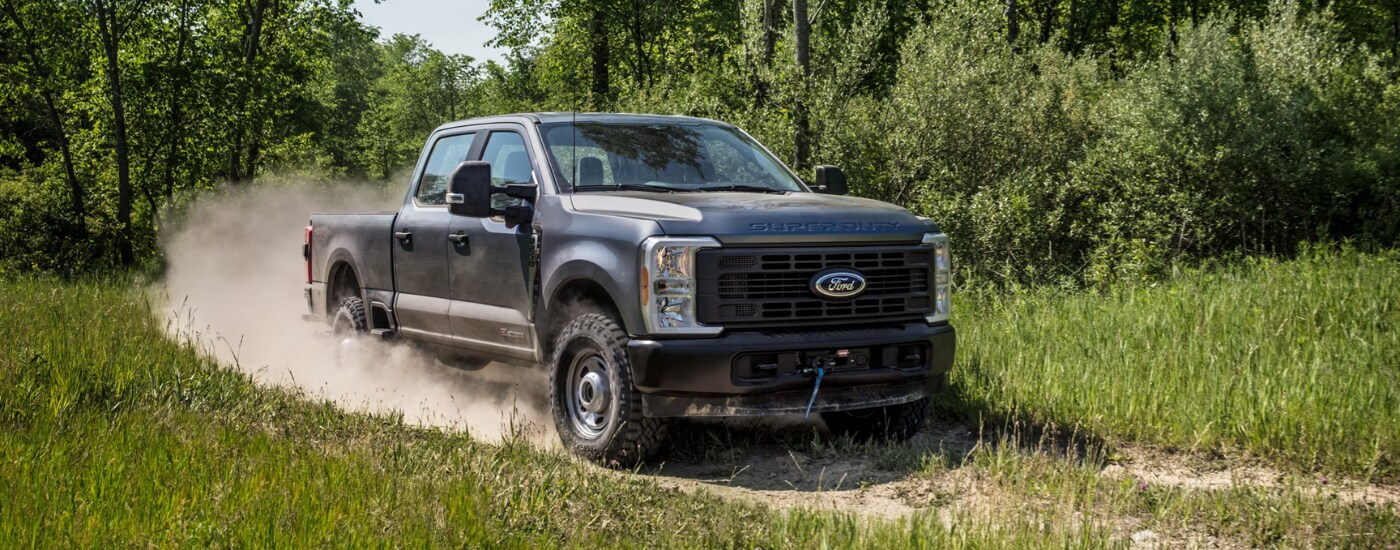 Grey 2026 Ford F-250 Super Duty driving to a car dealership near Toledo