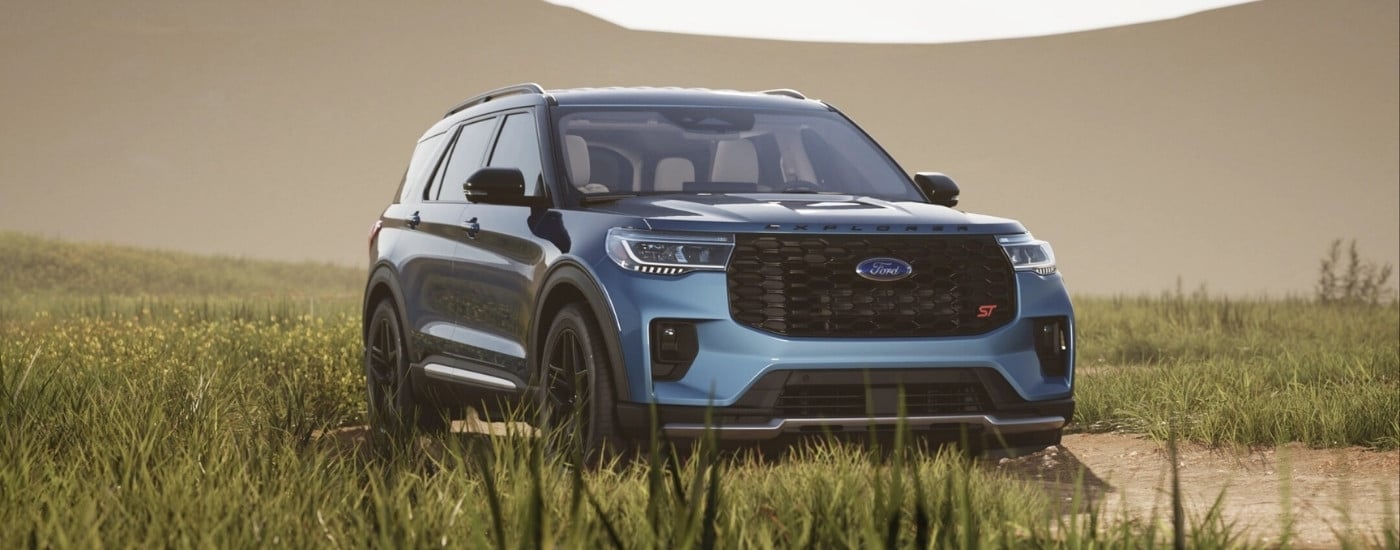 Blue 2025 Ford Explorer parked in tall grass