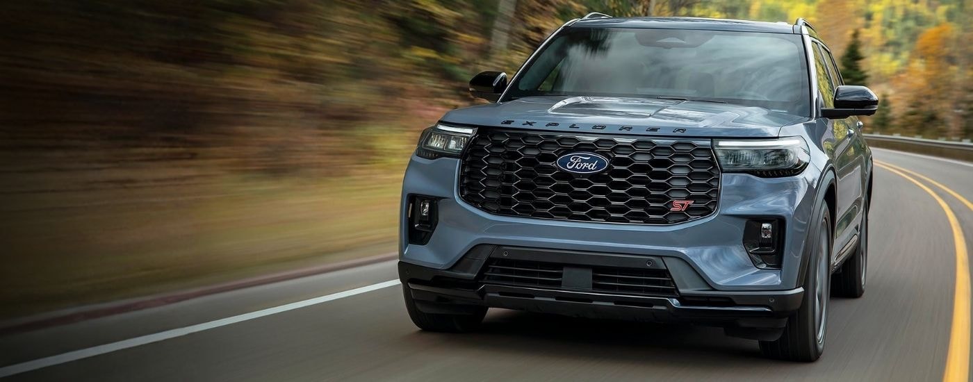 Blue 2027 Ford Explorer ST rounding a corner