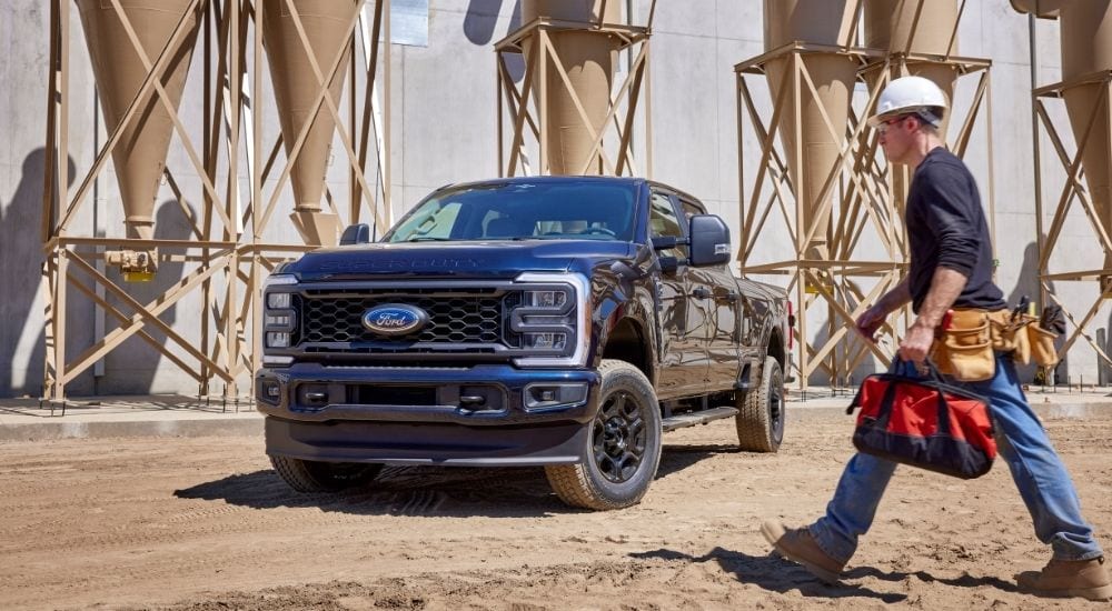 A black 2025 Ford F-250 XL STX parked at a construction site.