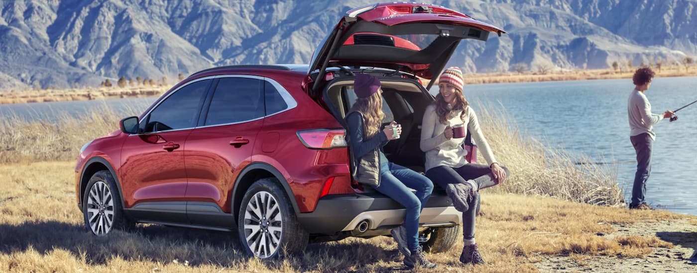 Red 2021 Ford Escape parked by water with the trunk open