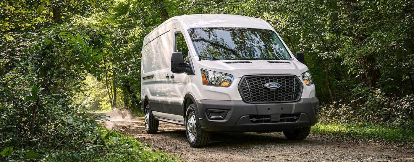 White 2021 Ford Transit Connect driving on a dirt road