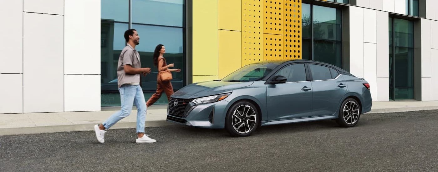 People walking near a light blue 2025 Nissan Sentra SR.