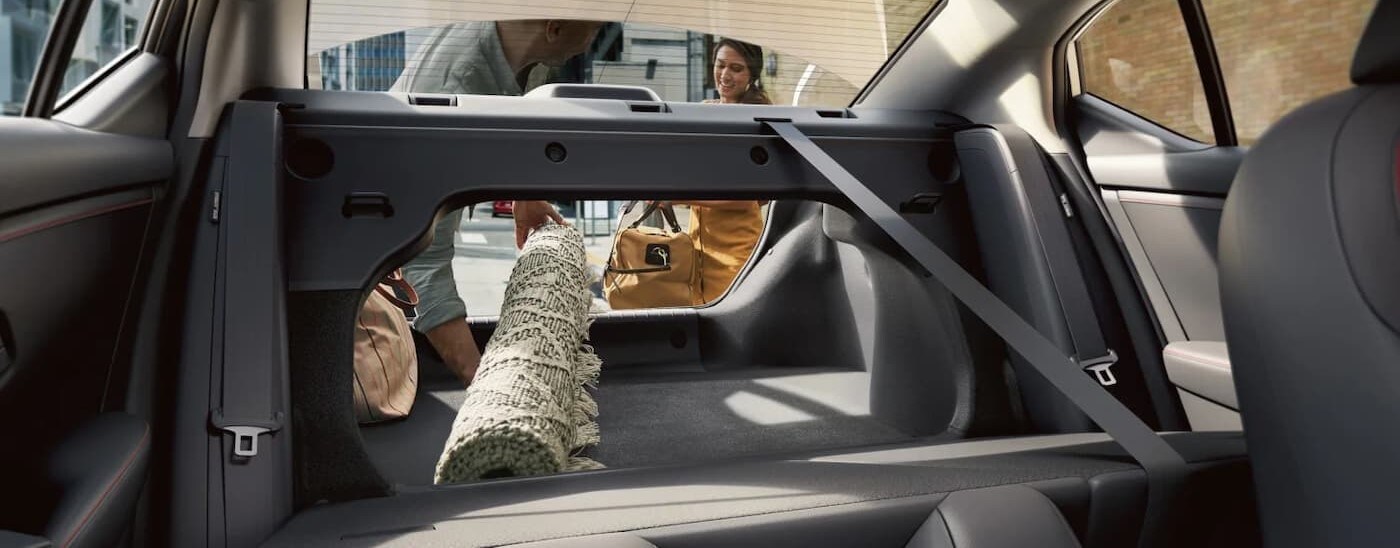Nissan Sentra for Sale Near Findlay - 2025 Nissan Sentra SR - rear cargo rug.jpg A rug being placed in the rear cargo area in a 2025 Nissan Sentra.