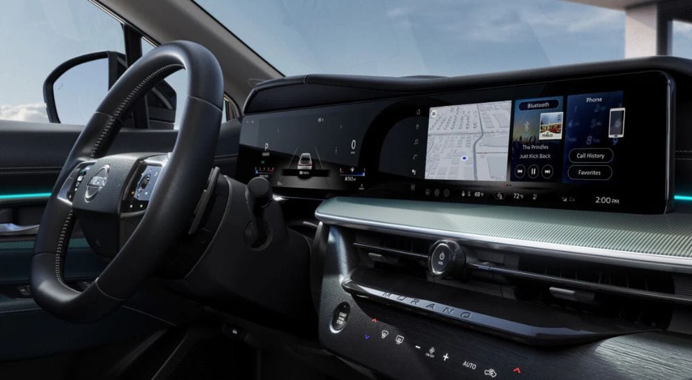 The steering wheel and infotainment screens in a 2025 Nissan Murano Platinum, available at Nissan dealers.