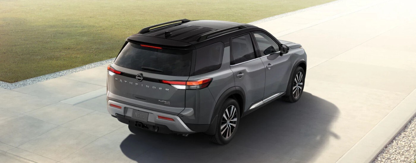 Rear view of a grey 2025 Nissan Pathfinder in a driveway.