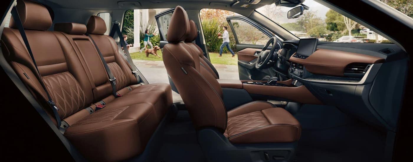 The black and brown interior and dash in a 2026 Nissan Rogue for sale near Troy.
