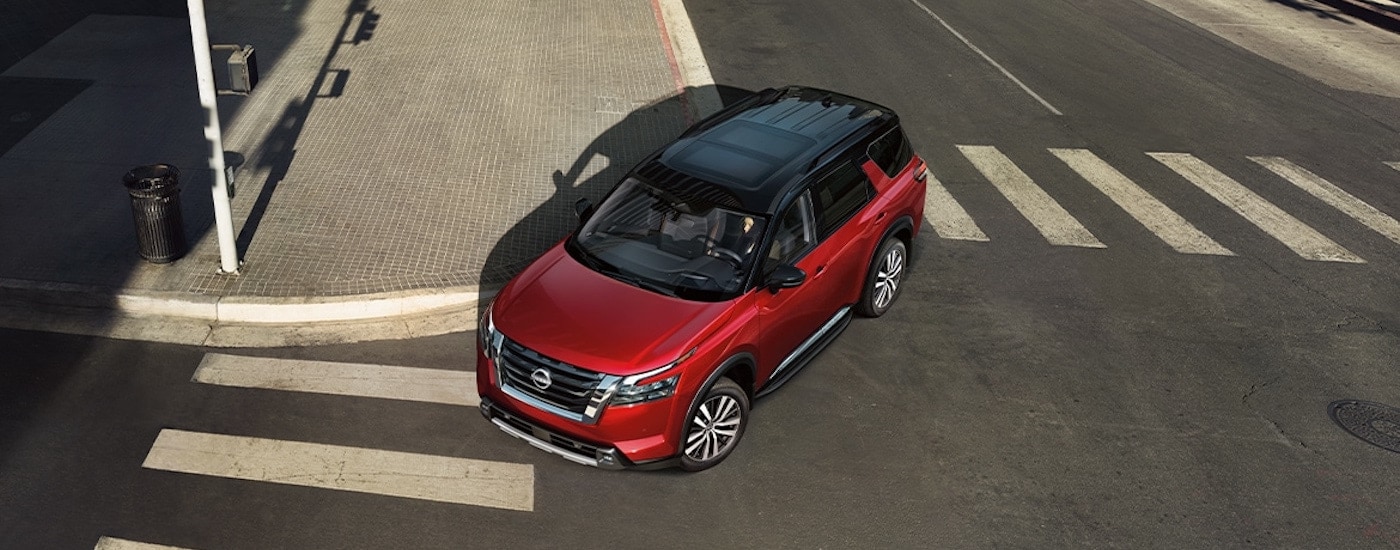 A red 2024 Nissan Rogue is shown from the front at a high andle after leaving a Nissan dealer near Findlay.