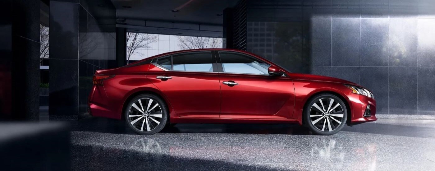 Side view of a red 2019 Nissan Altima parked in a building.