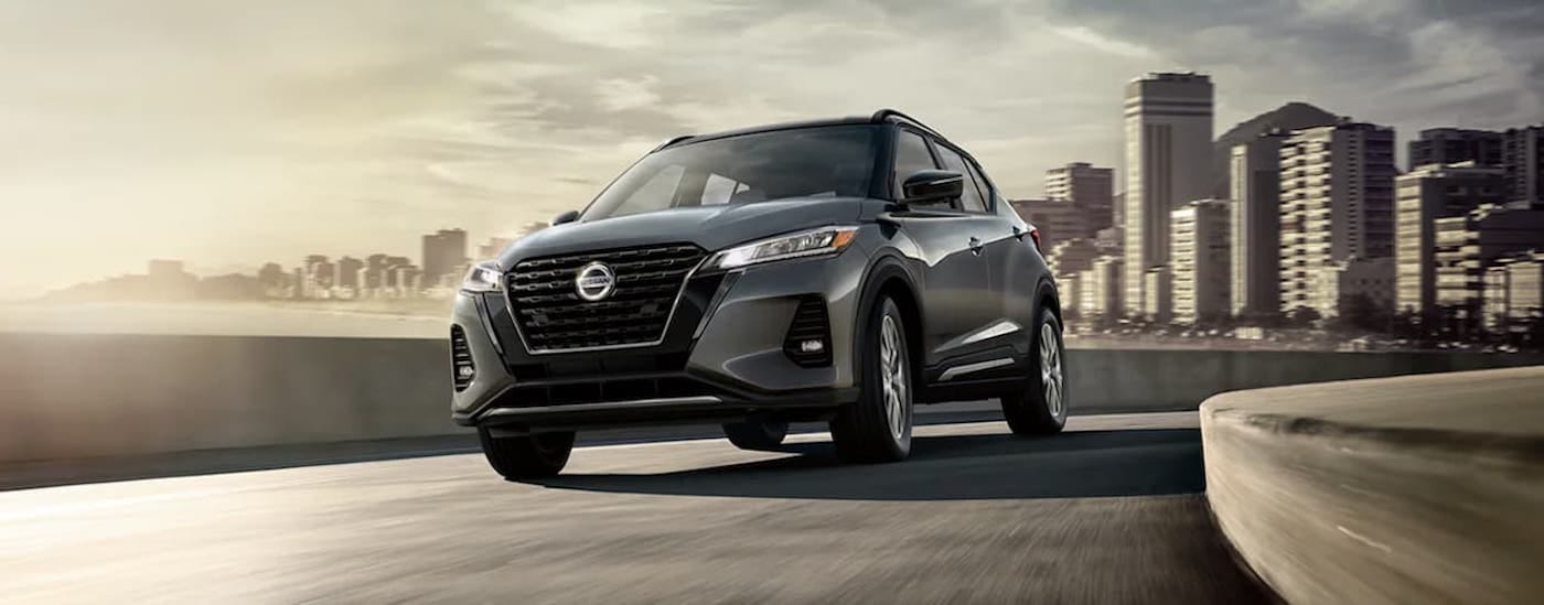 Grey 2025 Nissan Kicks SR for sale in Lima driving from a city.