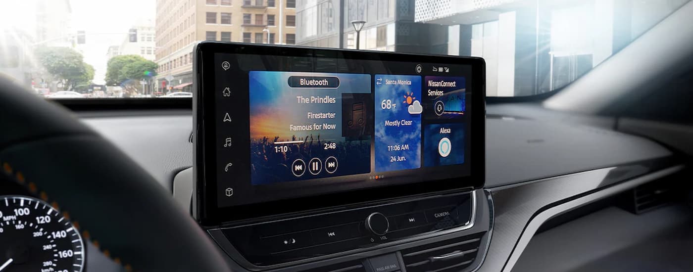 A close up of the center console and infotainment screen in a 2024 Nissan Altima.