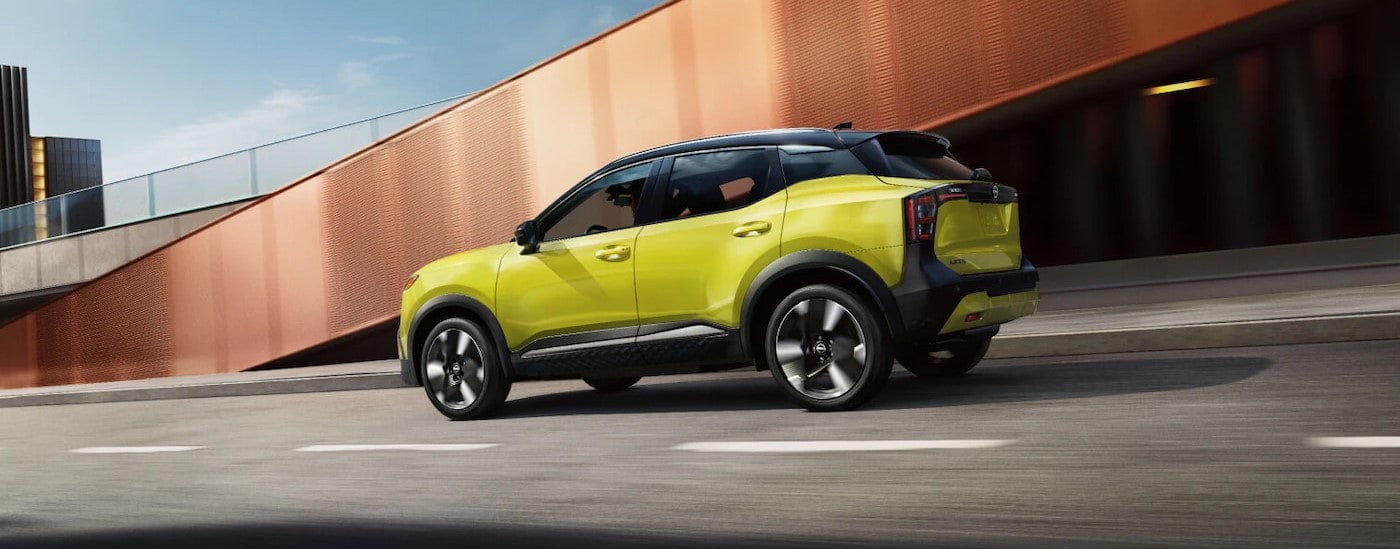 A yellow 2025 Nissan Kicks SR is shown driving to a Nissan dealer near Van Wert.