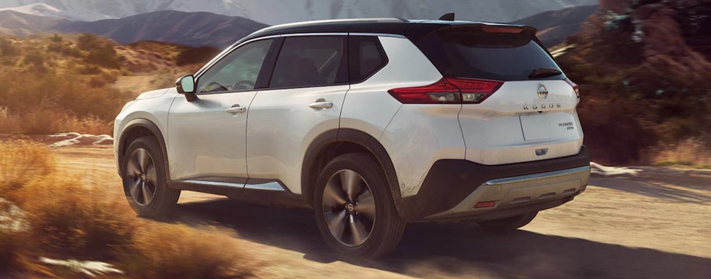 A white 2021 Nissan Rogue from the side.