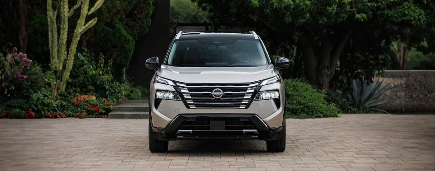A silver 2026 Nissan Rogue for sale in Lima is parked on a driveway.