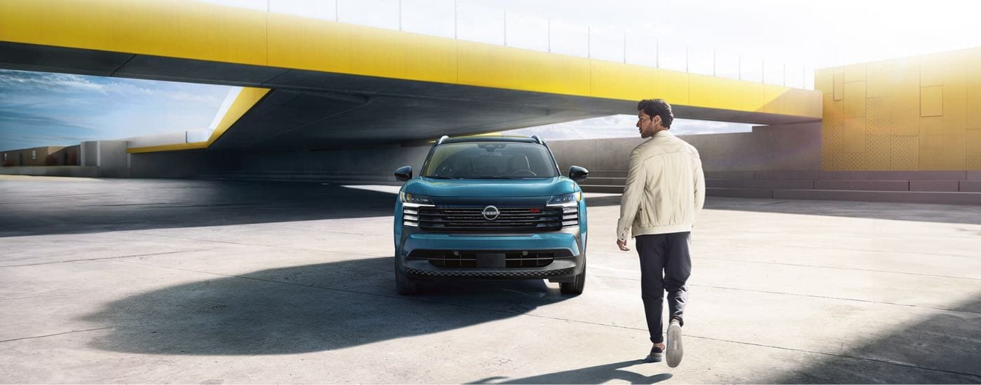 Light blue 2025 Nissan Kicks SR for sale near Van Wert parked underneath a bridge.