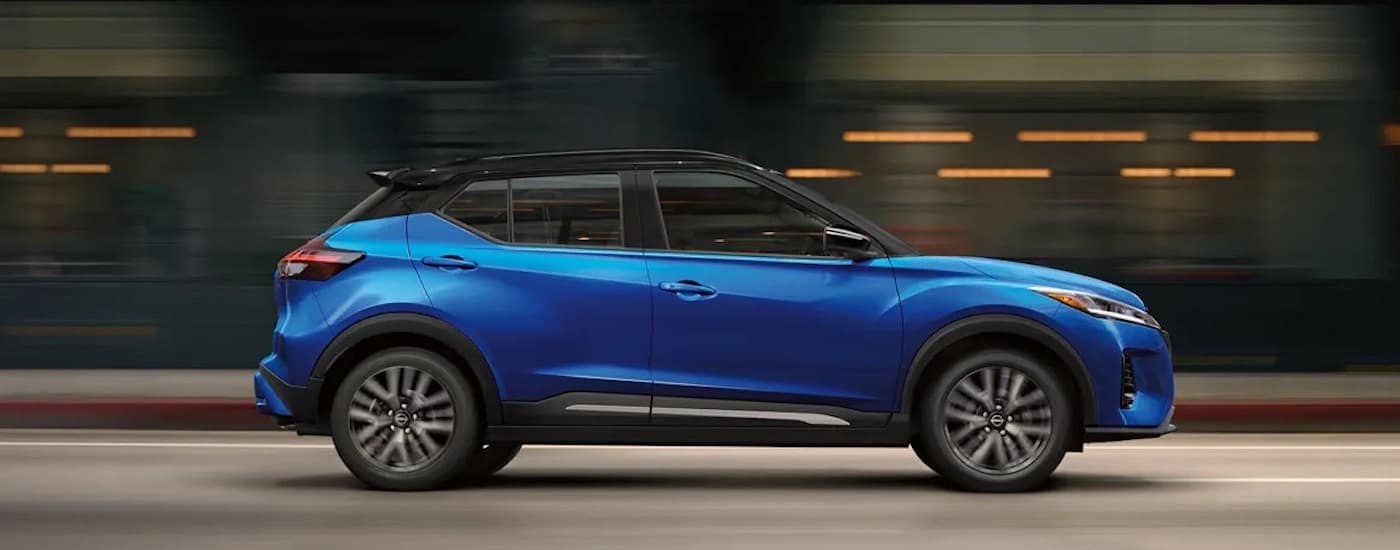 A blue 2023 Nissan Kicks is shown from the side.