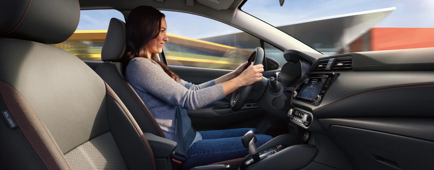 Woman driving in a 2025 Nissan Versa for sale