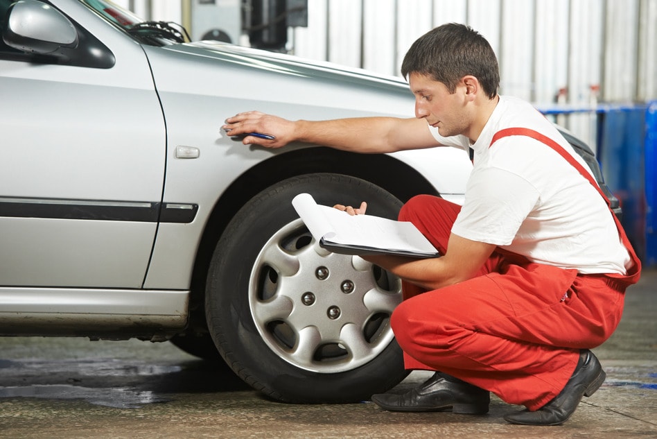 auto-mechanic-repairman-inspecting-car.jpg