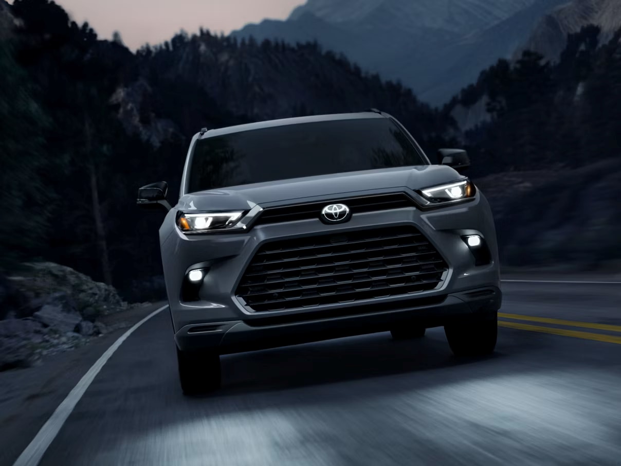 2026 Toyota Grand Highlander Hybrid driving on the highway at night