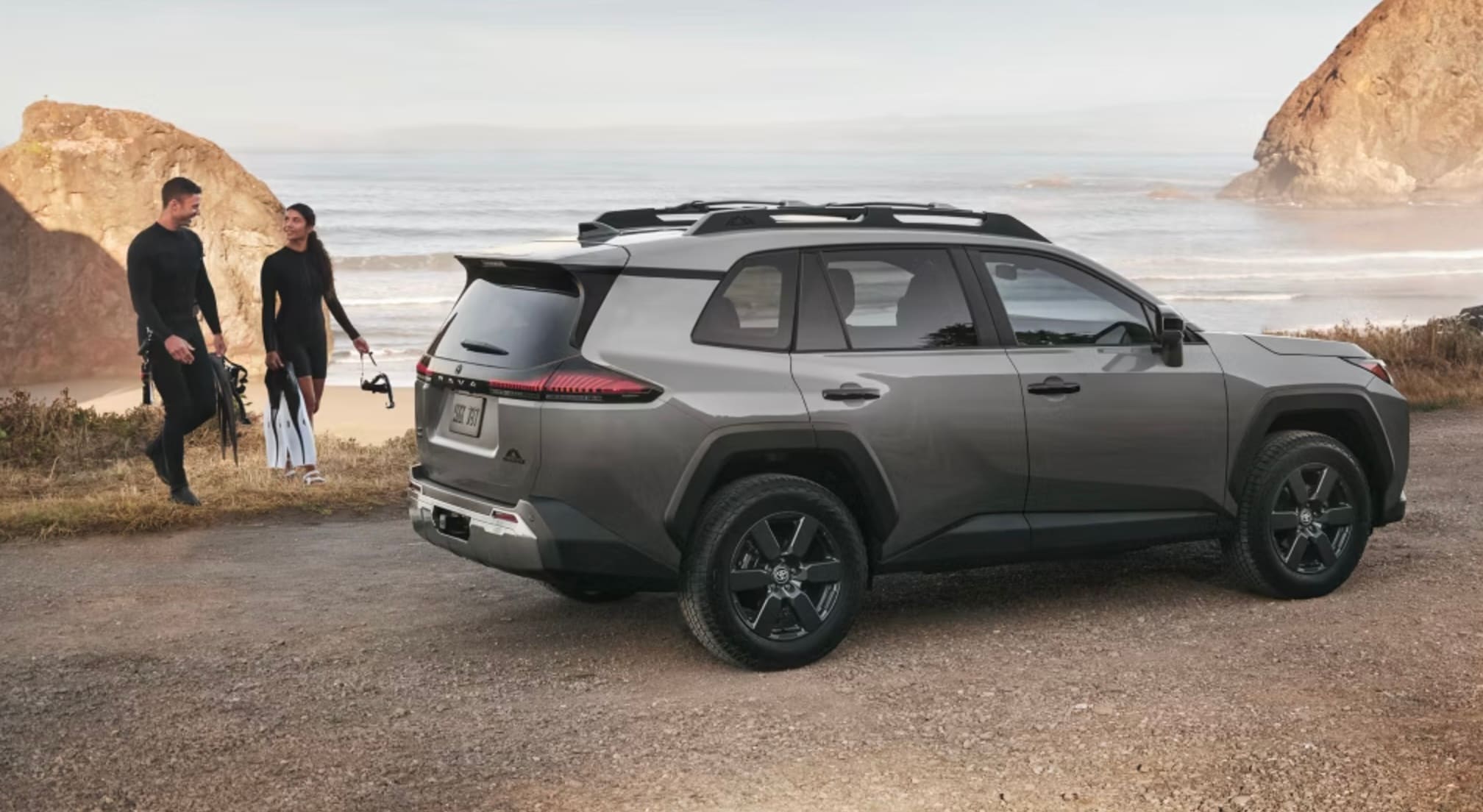  Two surfers walking back ti the RAV4 after taking a swim in the ocean.