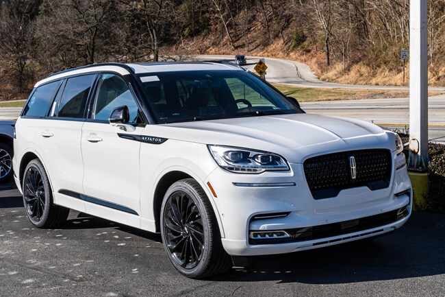 A white 2023 Lincoln Aviator SUV is parked on the street