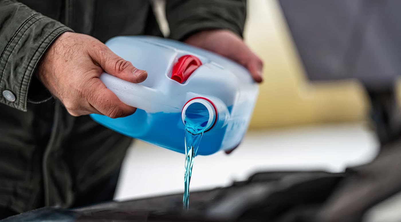 Mechanic Pouring Coolant