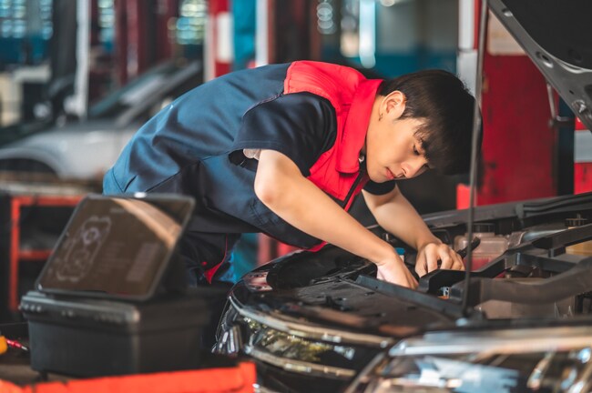 An auto mechanic checks the battery coolant level of the EV car. Electric car maintenance service